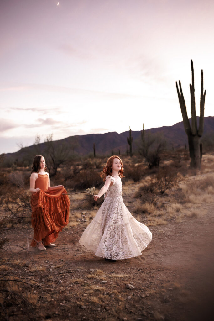 girls dancing at dusk in desert lifestyle family photoshoot