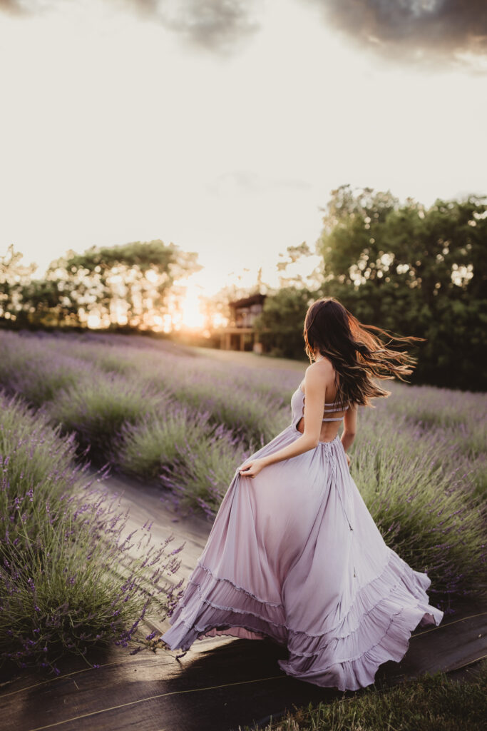 teenage girl twirling in a field of Iowa lavender