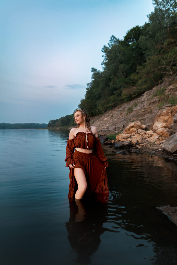 senior photos in the water during blue hour