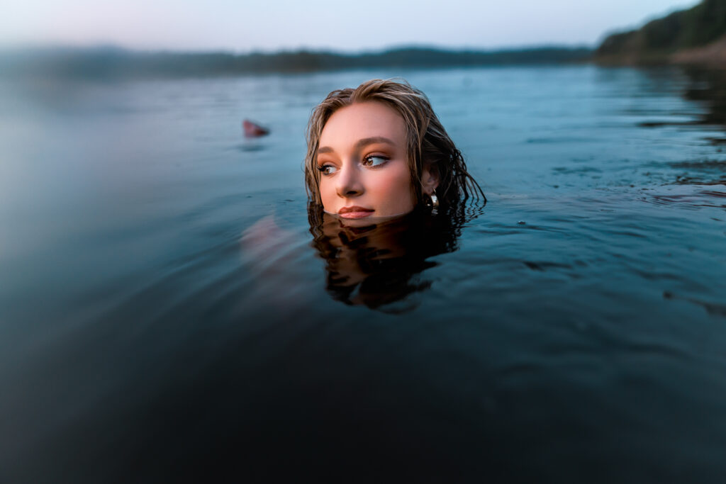 water shoot with girl looking off into the distance while nearly fully submerged