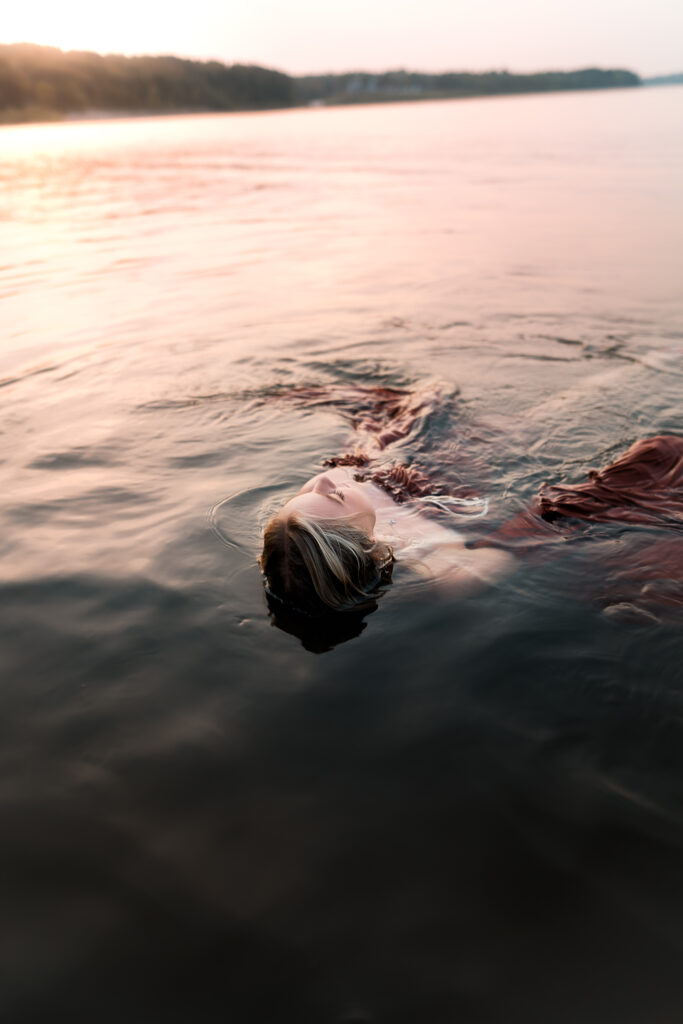 girl floating on her back in the lake