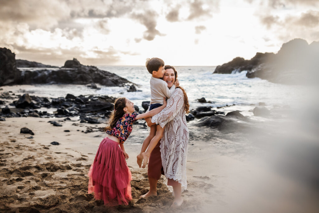 family giggles during photoshoot behind the scenes