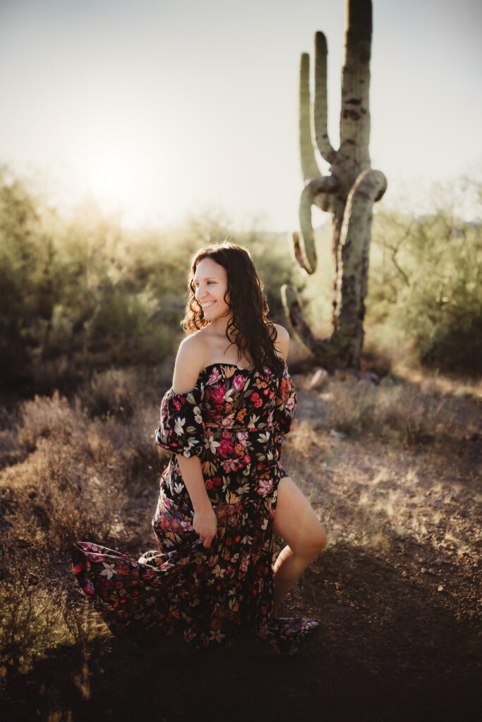 photo of happy woman taking her own photos in the desert